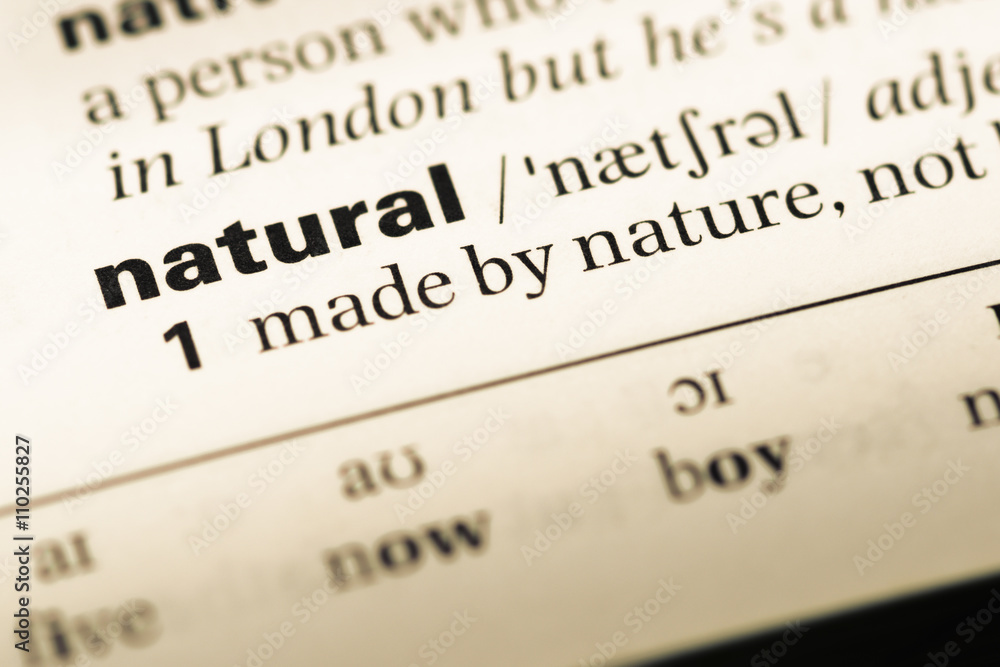 Close up of old English dictionary page with word natural Close up of old English dictionary page with word natural