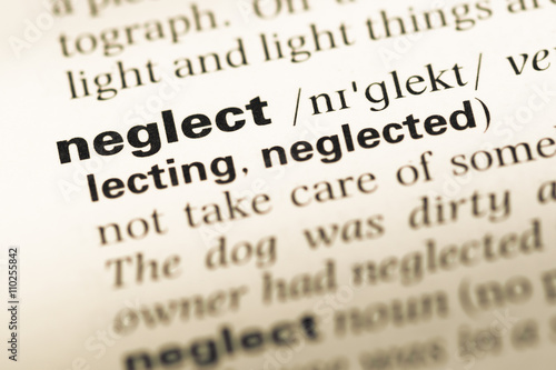 Close up of old English dictionary page with word neglect