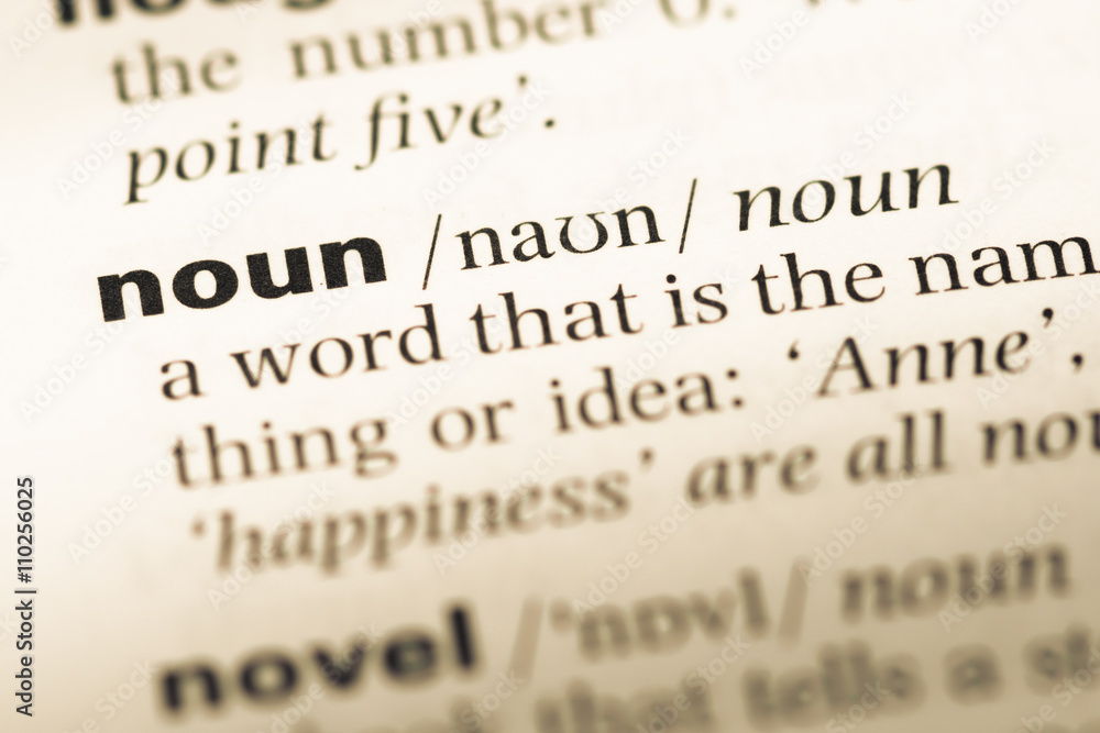 Close up of old English dictionary page with word noun StockFoto