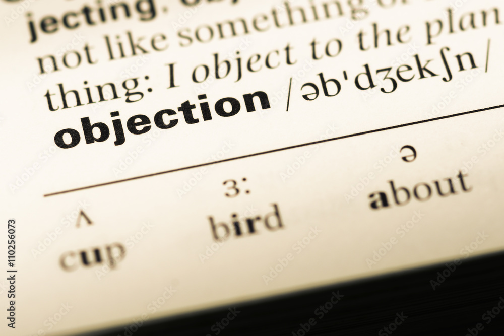 Close up of old English dictionary page with word objection Close up of old English dictionary page with word objection