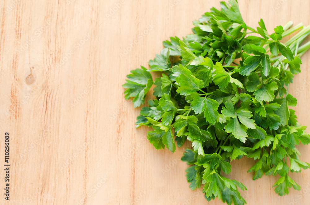 Organic fresh bunch of parsley on a wooden rustic table. Organic fresh bunch of parsley on a wooden rustic table.