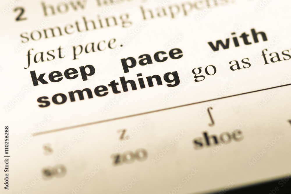 Close up of old English dictionary page with word keep pace with Close up of old English dictionary page with word keep pace with