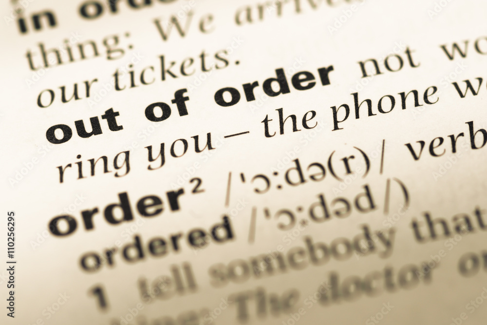 Close up of old English dictionary page with word out of order Close up of old English dictionary page with word out of order