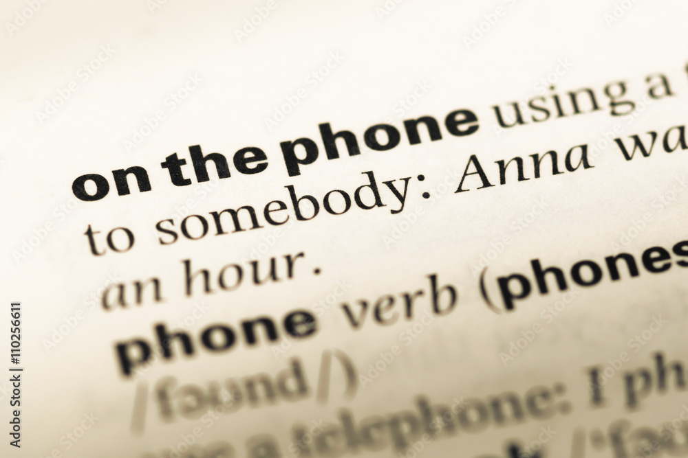 Close up of old English dictionary page with word on the phone Close up of old English dictionary page with word on the phone