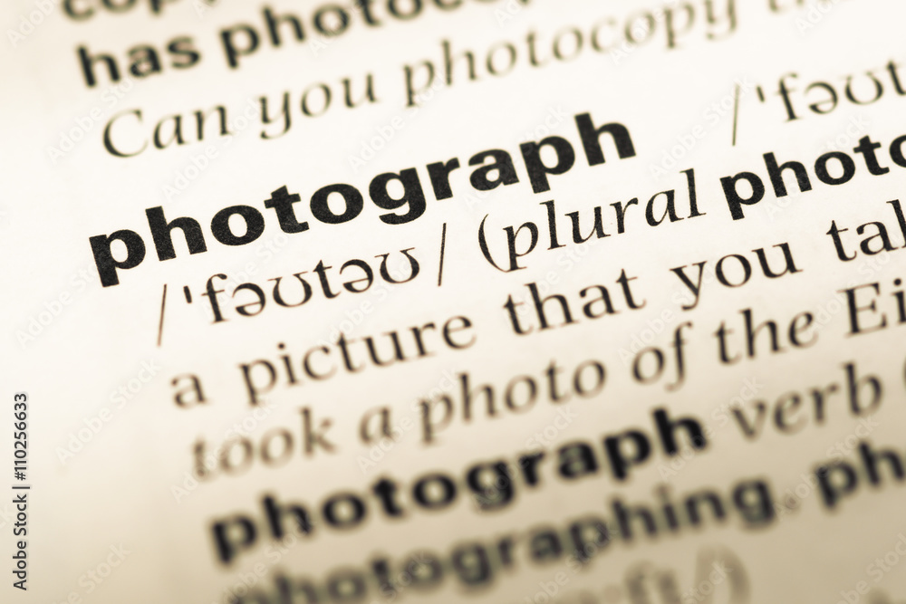 Close up of old English dictionary page with word photograph Close up of old English dictionary page with word photograph