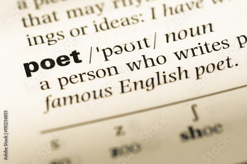 Close up of old English dictionary page with word poet