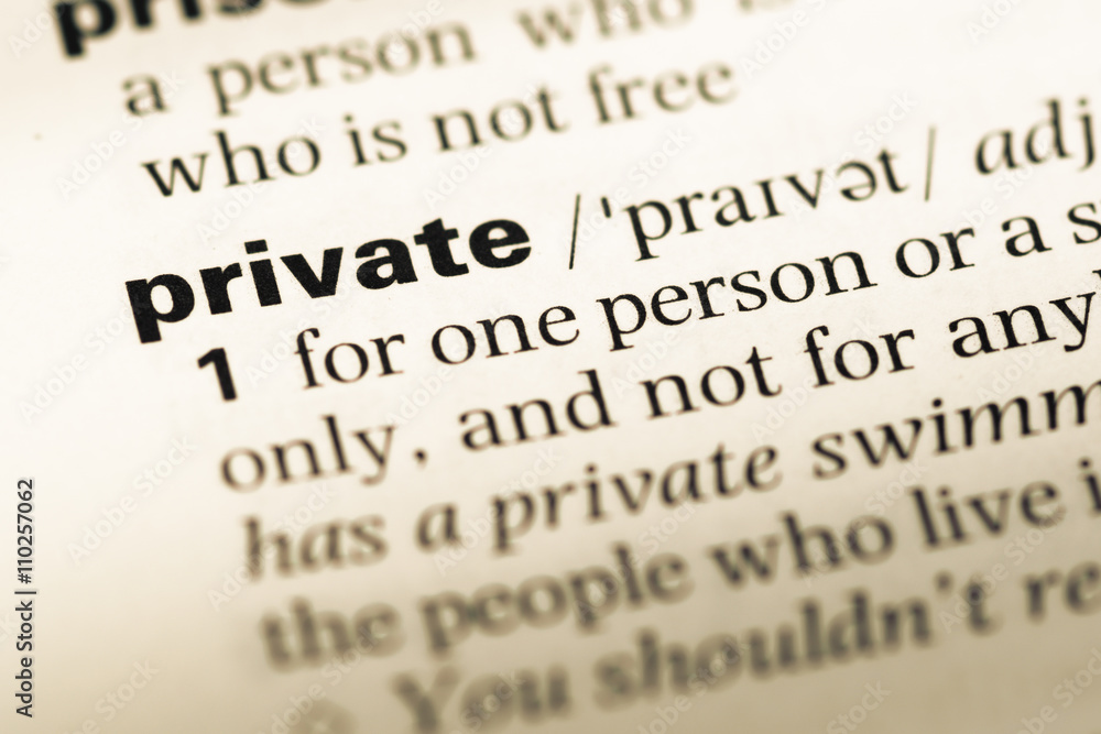 Close up of old English dictionary page with word private Close up of old English dictionary page with word private