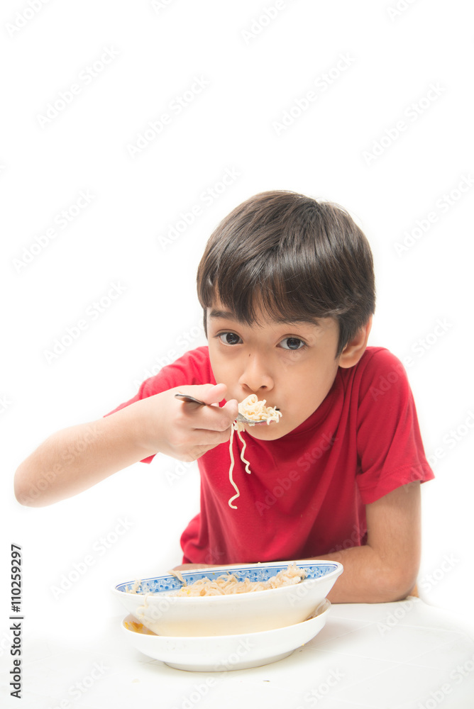 Little boy eating instant noodle on white background Little boy eating instant noodle on white background