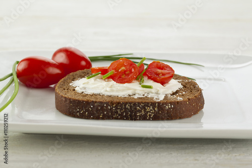 bread slice with creamy butter and tomatoes