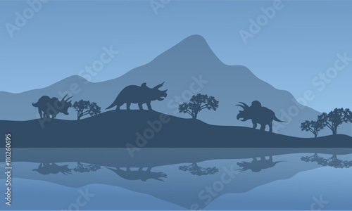 Fototapeta Naklejka Na Ścianę i Meble -  Silhouette of triceratops in the riverbank