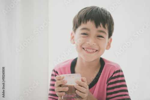 Little boy drinking milk vintage color style