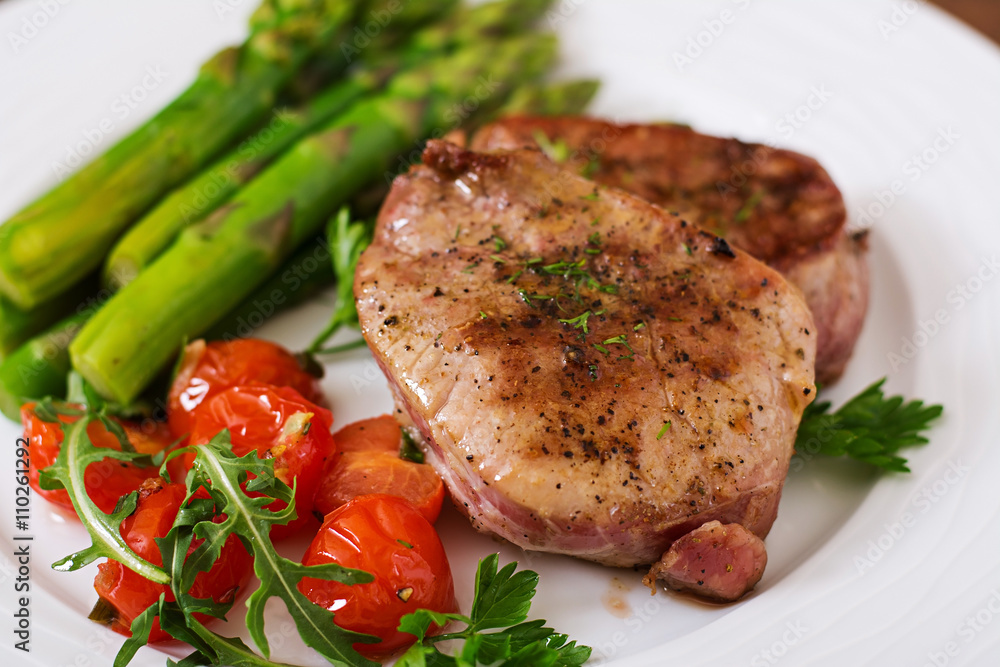 Barbecue grilled beef steak meat with asparagus and tomatoes. Barbecue grilled beef steak meat with asparagus and tomatoes.
