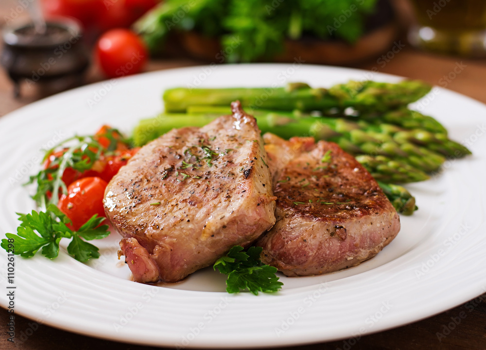Barbecue grilled beef steak meat with asparagus and tomatoes. Barbecue grilled beef steak meat with asparagus and tomatoes.