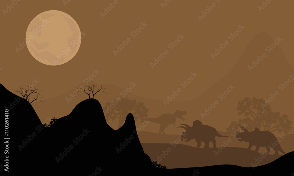 Silhouette of triceratops with moon at night