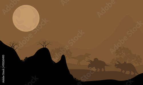 Silhouette of triceratops with moon at night
