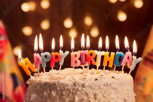 Photos Birthday cake with candles, bright lights bokeh.Celebration.