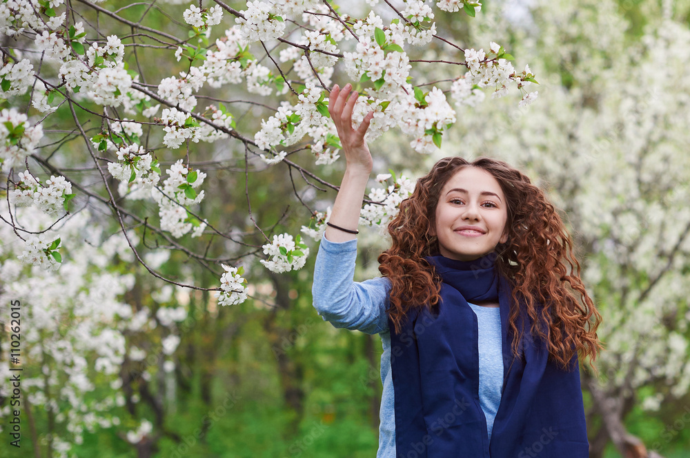 young woman in the blossoming spring garden walks young woman in the blossoming spring garden walks