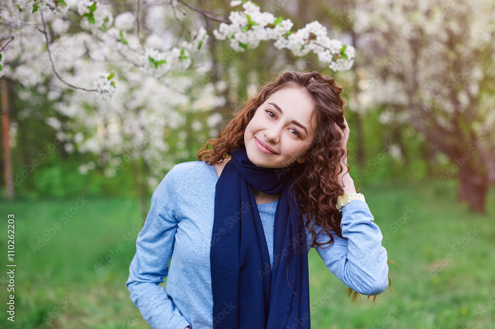 young woman in the blossoming spring garden walks young woman in the blossoming spring garden walks