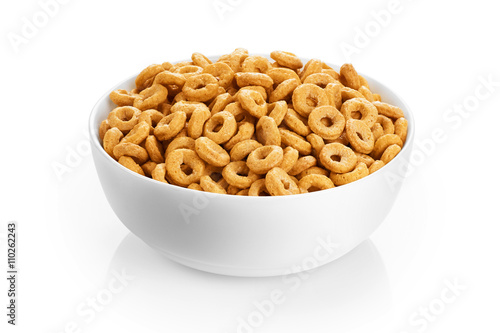 Foto Bowl with corn rings isolated on white background. Cereals.