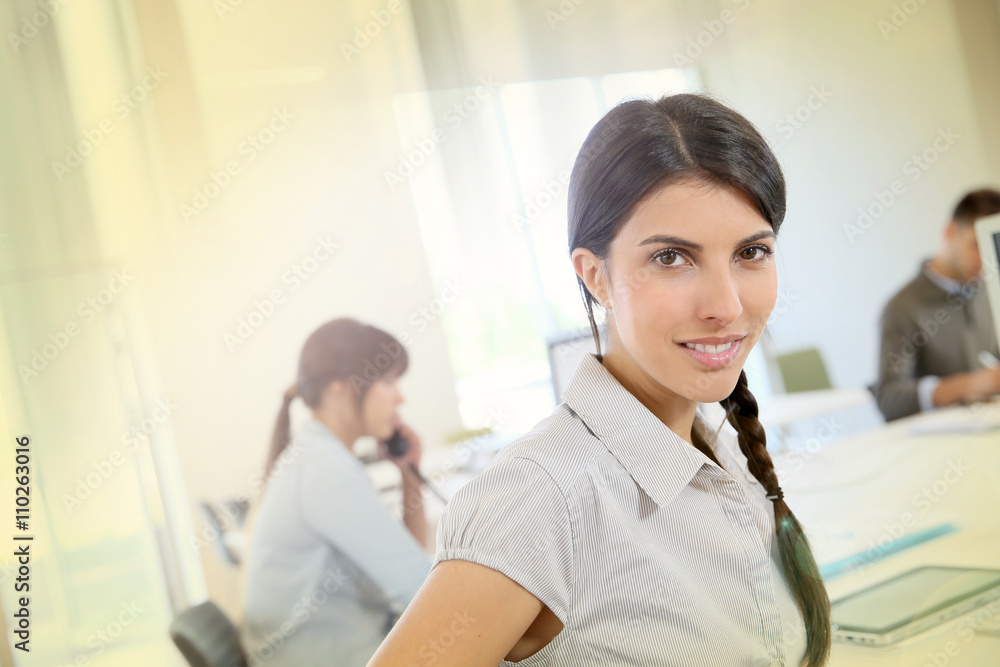 Portrait of young brunette woman working in office Portrait of young brunette woman working in office