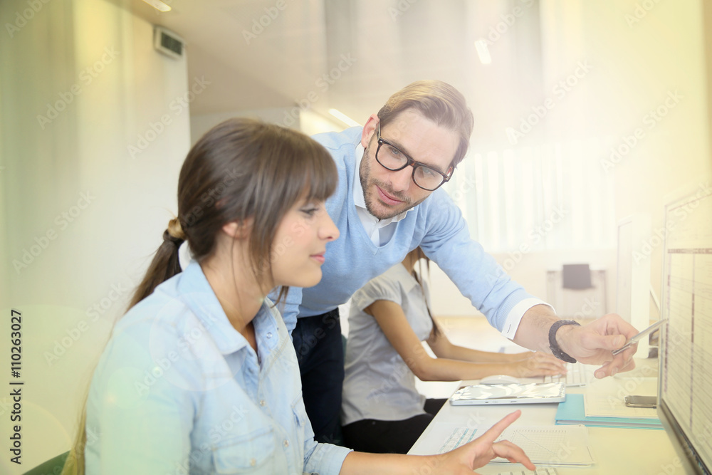 Business people working in office on desktop computer Business people working in office on desktop computer