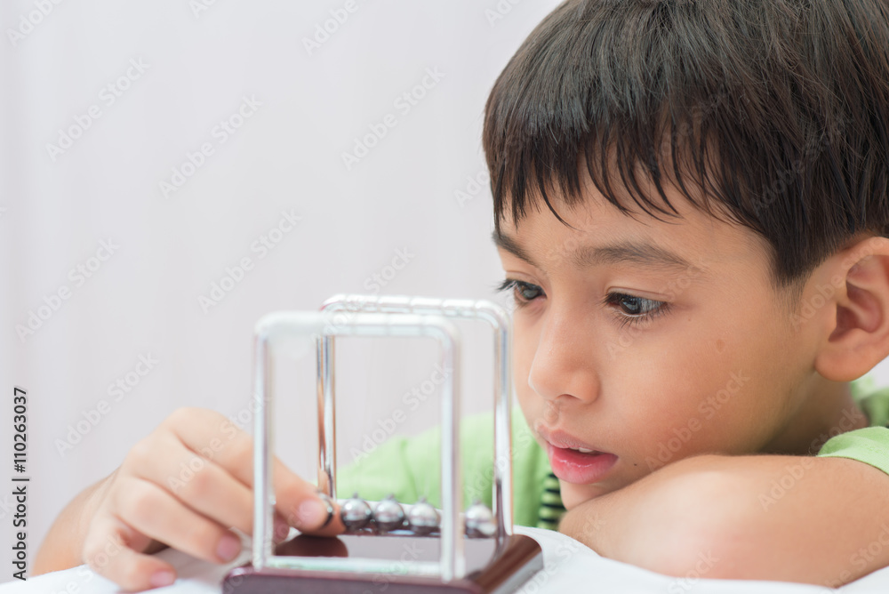 Little boy learning newton balance ball for science physic Little boy learning newton balance ball for science physic