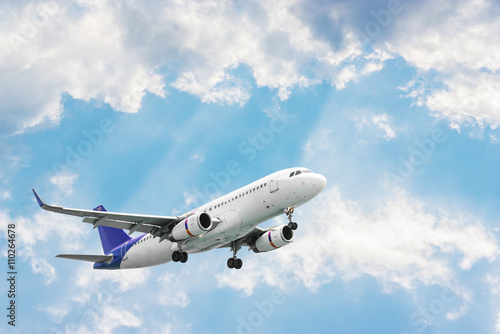 Airplane flying on blurred blue sky