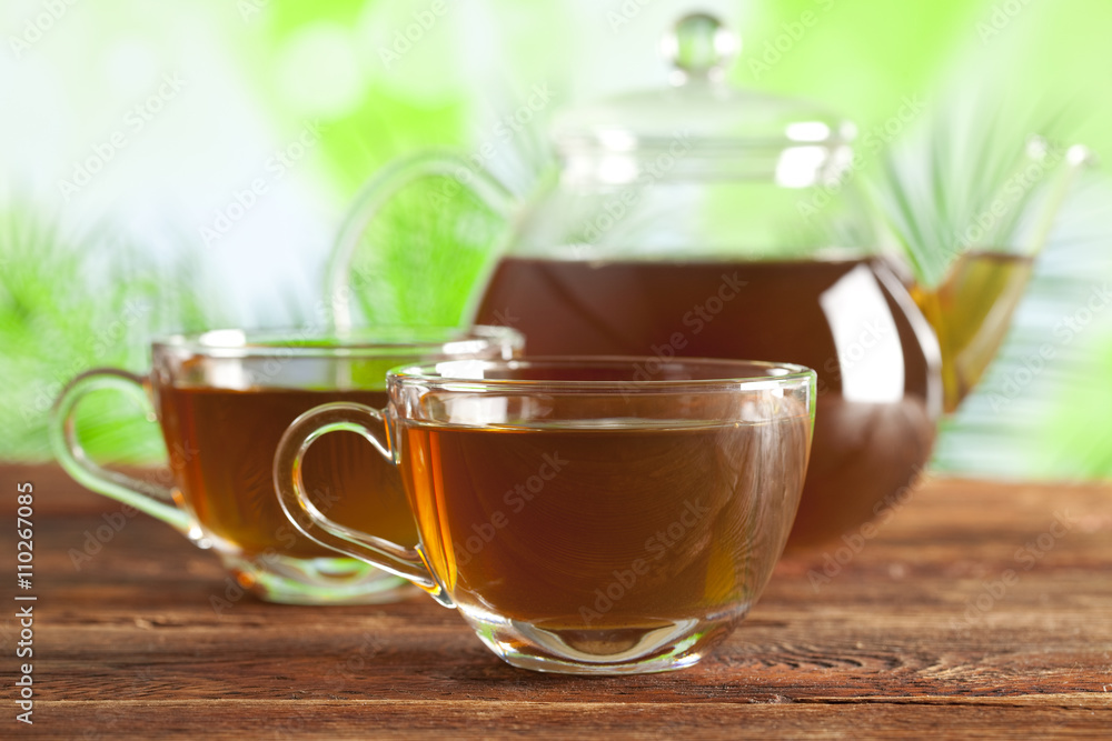 Cup of tea and teapot on nature background Cup of tea and teapot on nature background