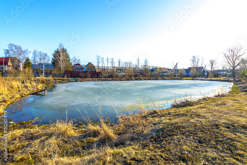 Frozen pond in spring countryside
