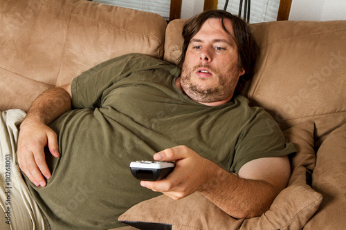 Fat lazy guy on the couch photo
