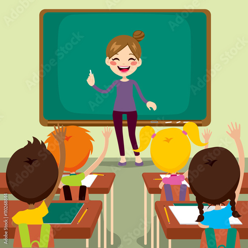 Beautiful happy young teacher woman standing teaching in front children raising hands up sitting in classroom