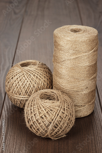 reel and balls of durable thread on the wooden table