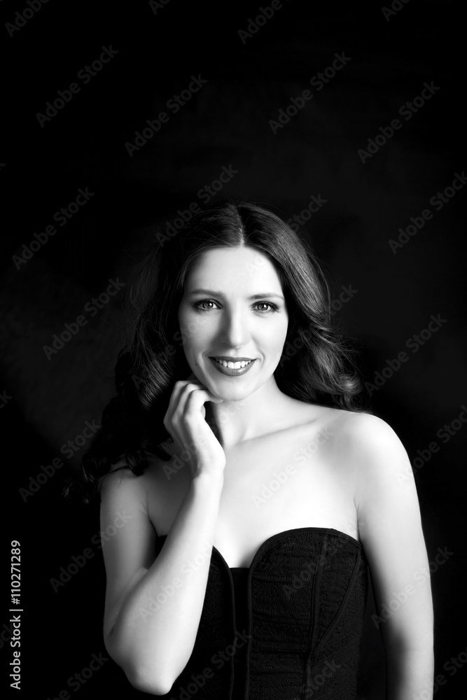Portrait of beautiful woman in black dress with curly hair - isolated on dark background. Portrait of beautiful woman in black dress with curly hair - isolated on dark background.