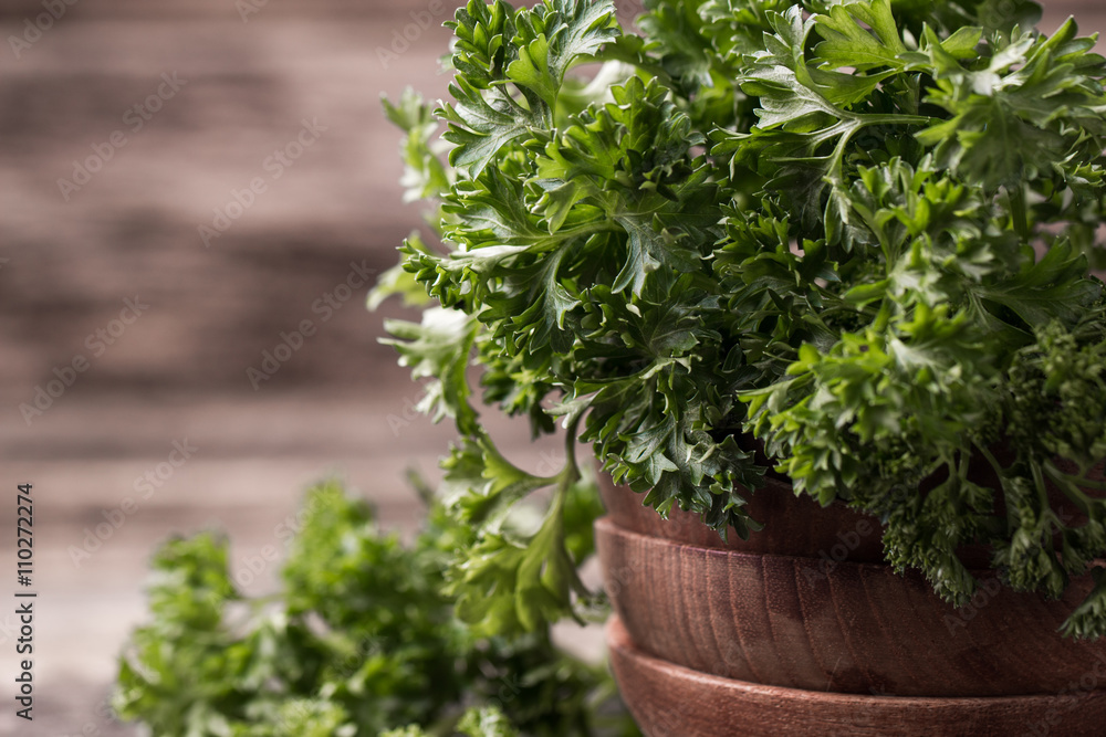 Fototapeta premium tied fresh parsley on wooden surface, healthy food