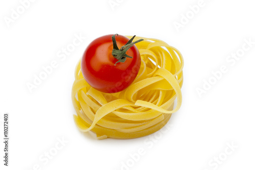 fettuccine noodles nest with a tomato