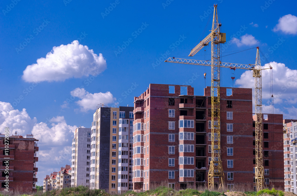 Construction of a brick high-rise building with a crane Construction of a brick high-rise building with a crane