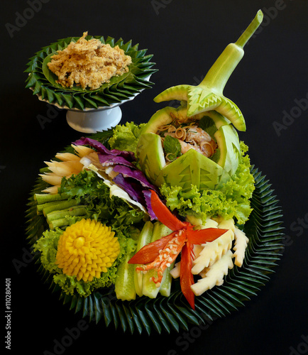 authentic thai cuisine - sangwa pla dook foo - thai grilled shrimp salad with traditional herbs, served with vegetables and crispy fluffy catfish photo