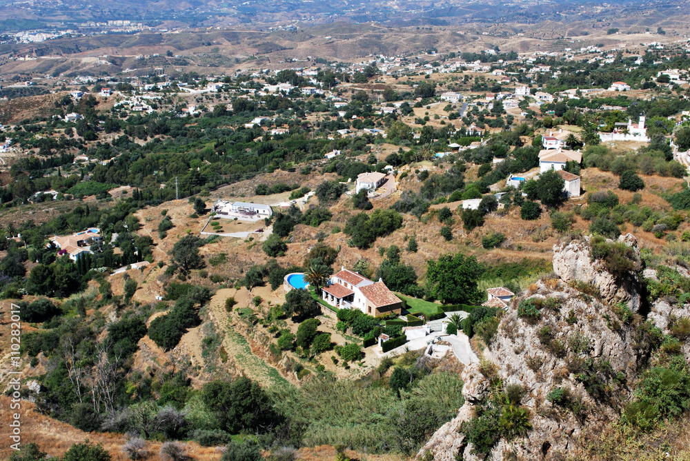 Elevated view of villas with swimming pools and surrounding mountain landscape near Mijas.