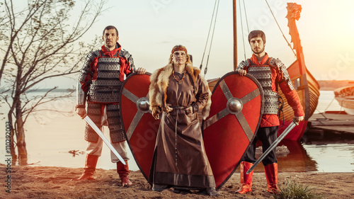 Slavic princess and two warriors with swords and shields on the