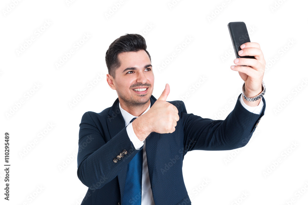Happy businessman making a selfie and showing thumb up Happy businessman making a selfie and showing thumb up