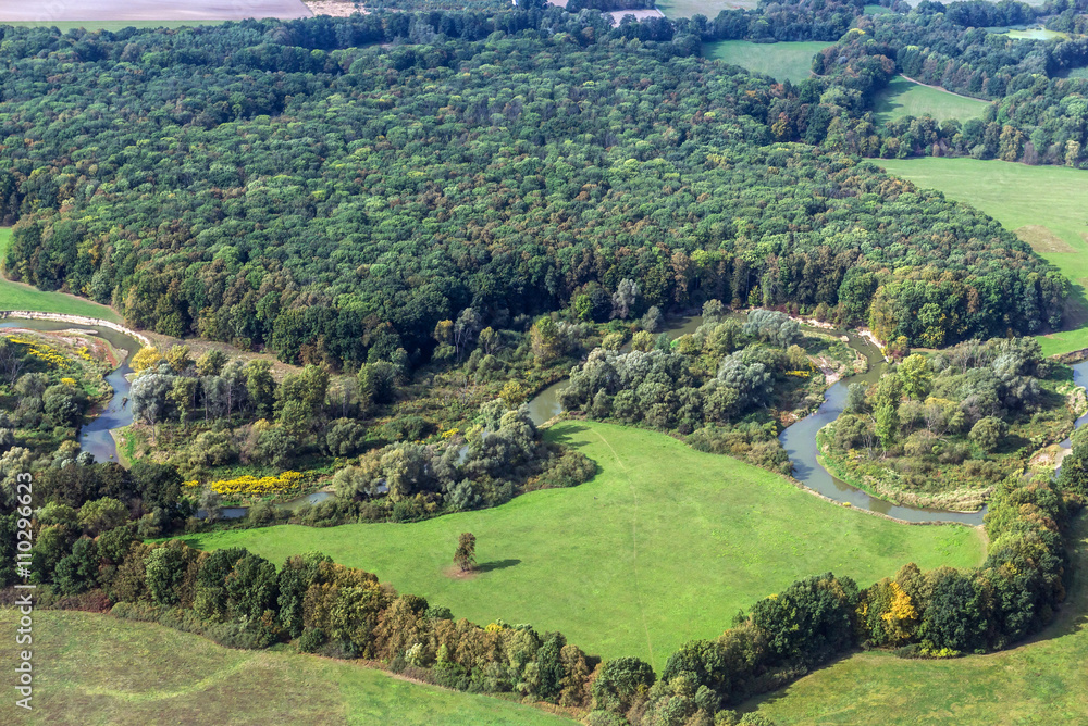 fields and forest seen from airplane window during approaching Warsaw's airport, Poland