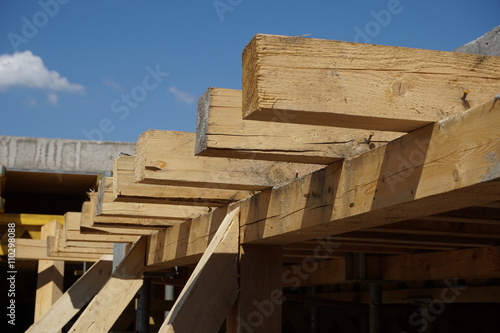 Wooden beam supporting construction of the concrete roof on the building site 