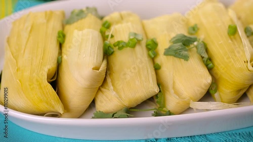 Home made tamales on serving plate on the party table