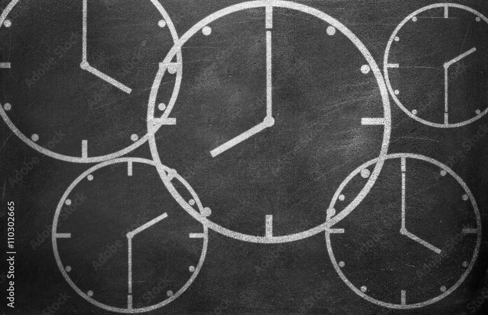 Clock from chalk on black chalkboard background texture
