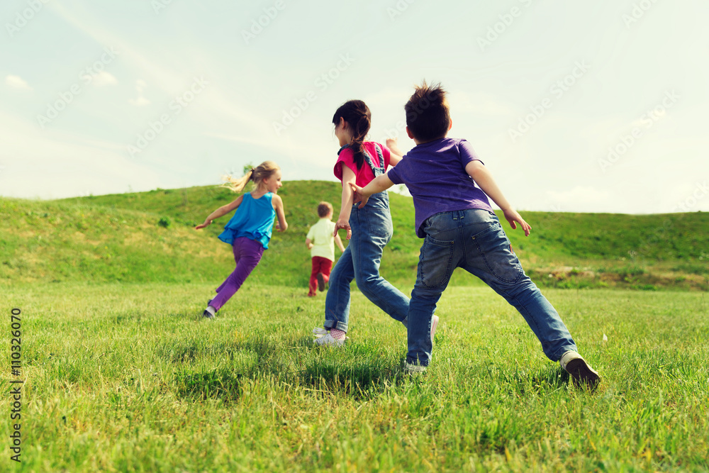 group of happy kids running outdoors group of happy kids running outdoors
