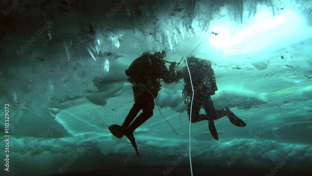 Unique extreme underwater shooting scuba dive beneath ice at geographic North Pole in cold waters. Fantastic views of the lump of ice in water. ICE CAMP BARNEO, NORTH POLE, ARCTIC - APRIL 2015 Unique extreme underwater shooting scuba dive beneath ice at geographic North Pole in cold waters. Fantastic views of the lump of ice in water. ICE CAMP BARNEO, NORTH POLE, ARCTIC - APRIL 2015