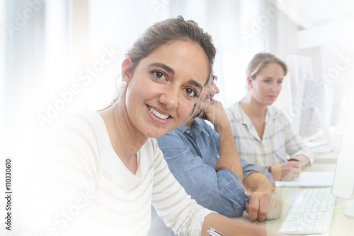 Portrait of smiling brunette school girl in class
