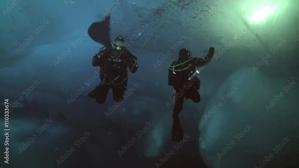 Unique extreme underwater shooting scuba dive beneath ice at geographic North Pole in cold waters. Fantastic views of the lump of ice in water. ICE CAMP BARNEO, NORTH POLE, ARCTIC - APRIL 2015 Unique extreme underwater shooting scuba dive beneath ice at geographic North Pole in cold waters. Fantastic views of the lump of ice in water. ICE CAMP BARNEO, NORTH POLE, ARCTIC - APRIL 2015