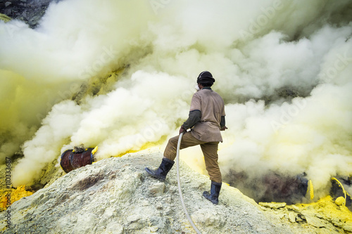 Sulfur miner at work inside the crater of Kawah Ijen vocano, East Java, Indonesia. photo