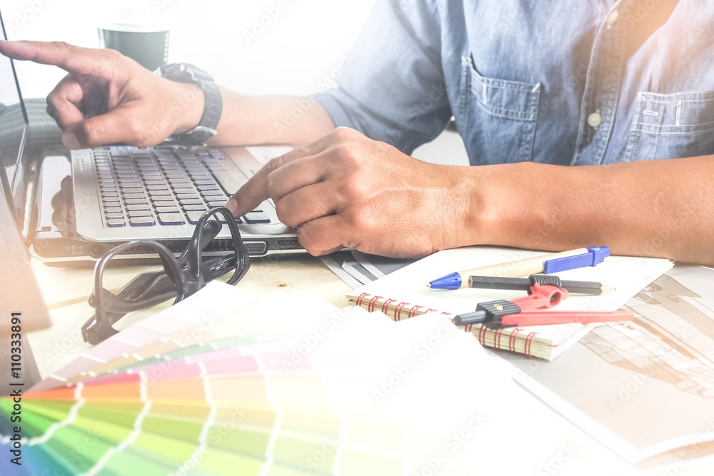 interior design using computer for presentation on wooden desk,selective focus at front hand